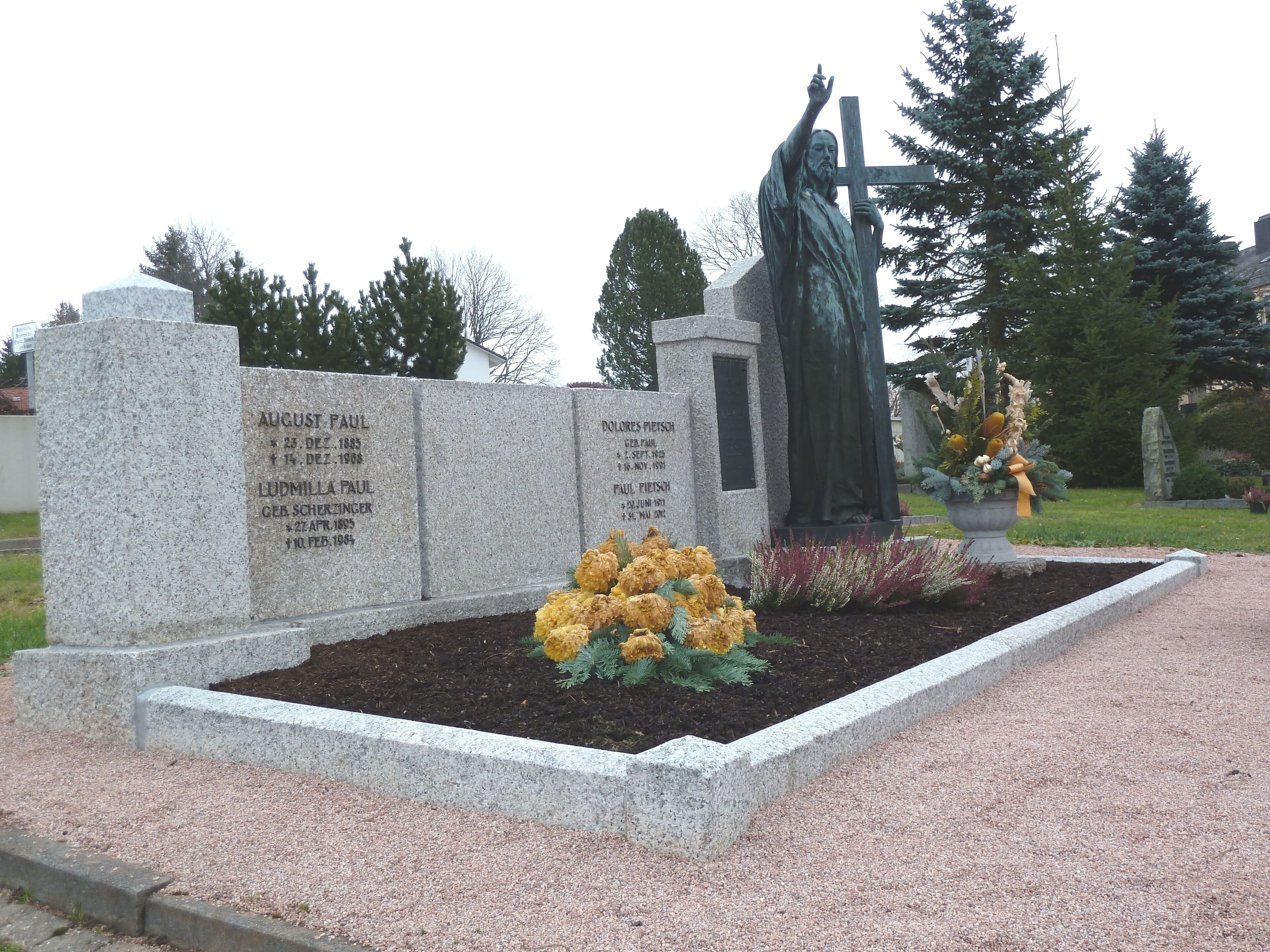 A cemetery with gravestones and a statue.