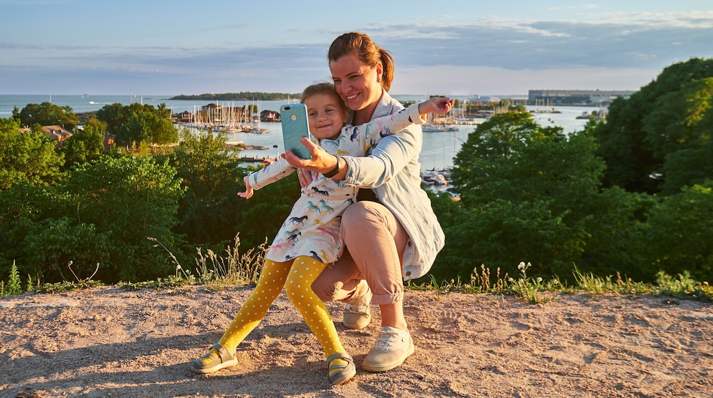 Young mother and her daughter taking a selfie, sea on background, Kaivopuisto park, Helsinki, Finland