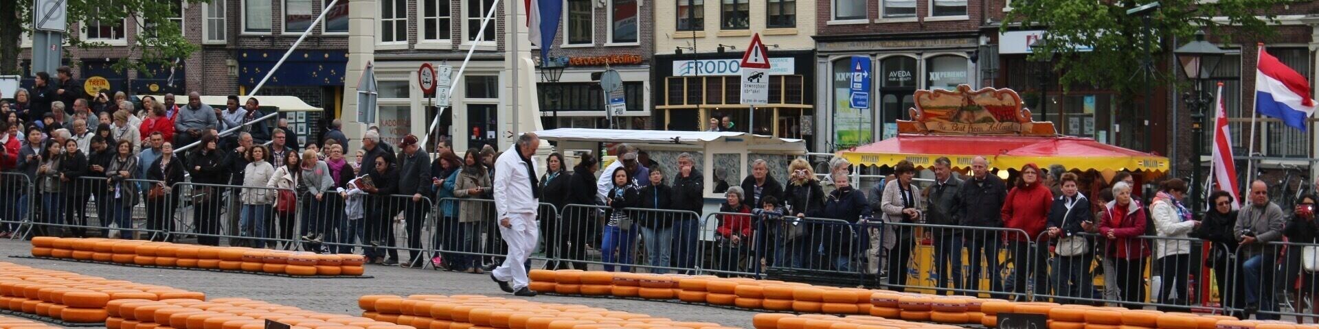 Cheese Market filled with cheese and cheese carriers with white uniforms.