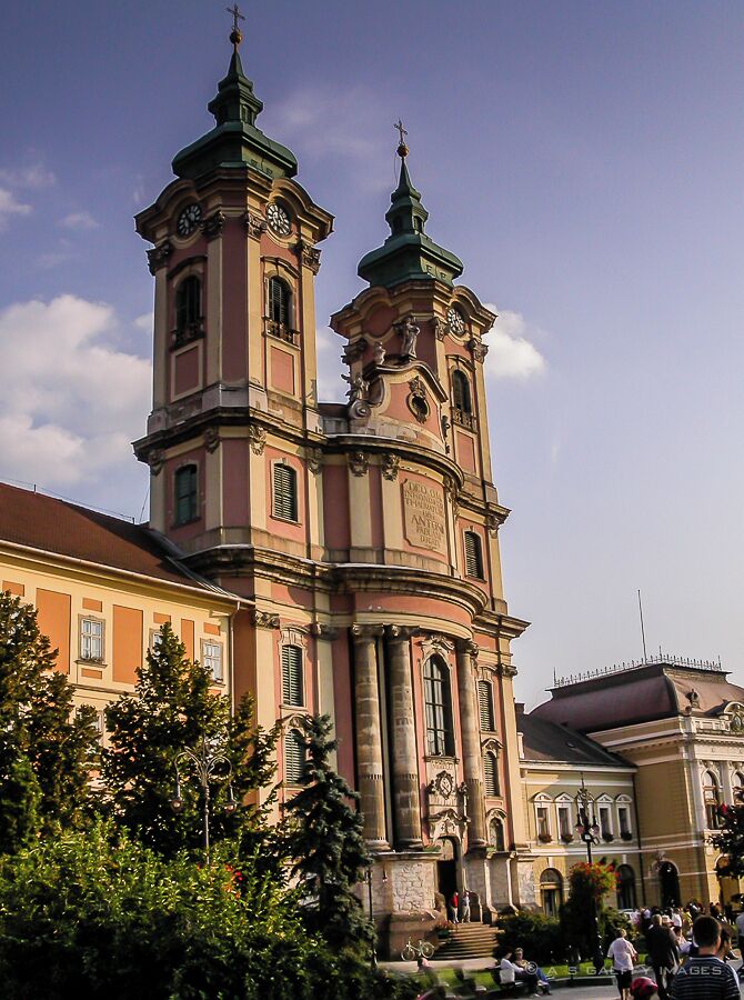 A historic church with two towers and a clock on each.