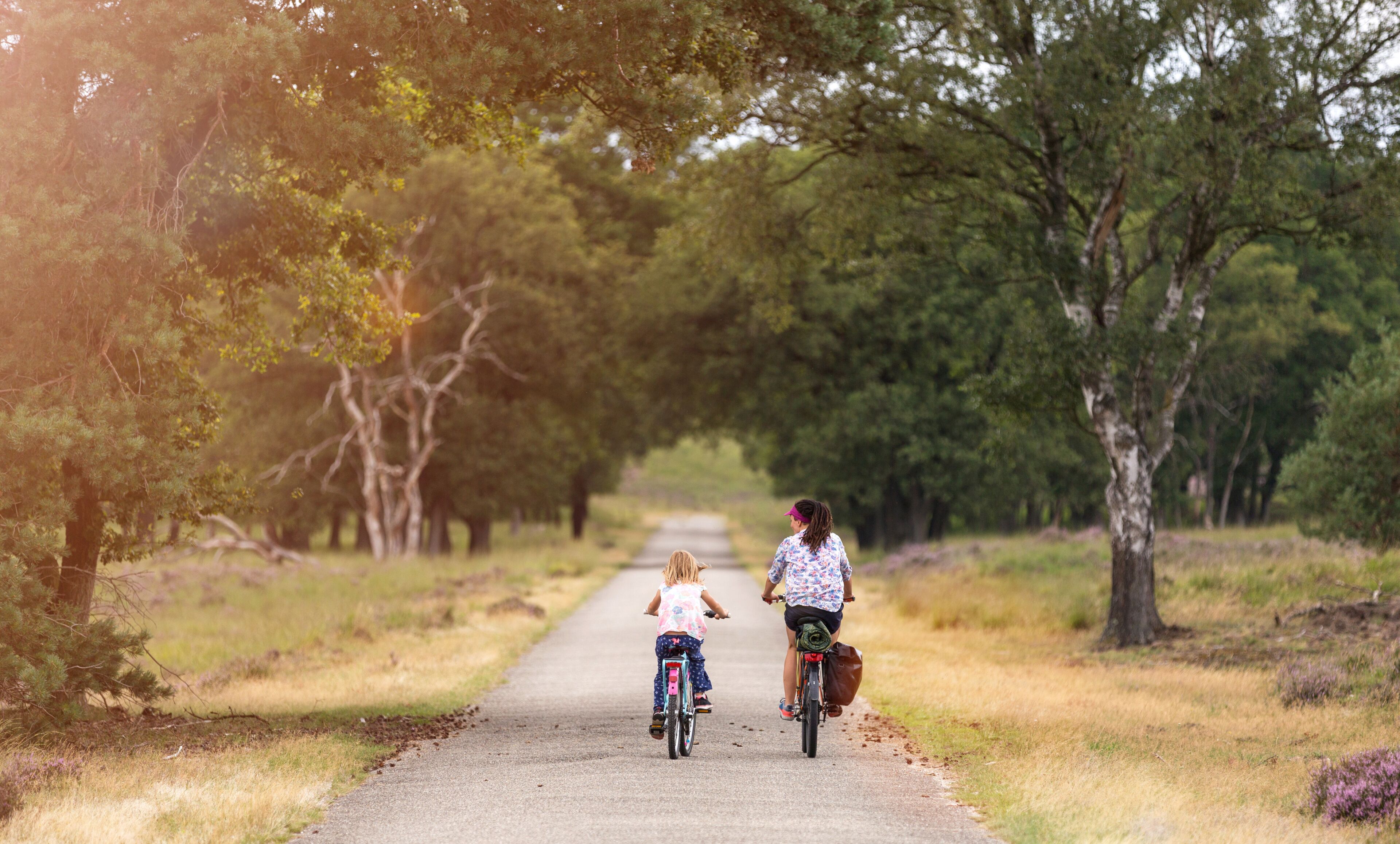 Little girl cycling with her mother in Holland