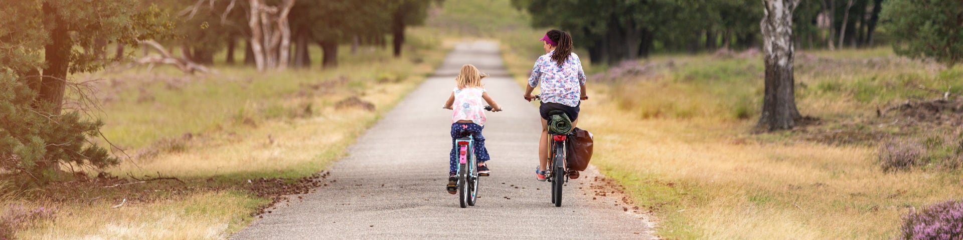 Little girl cycling with her mother in Holland