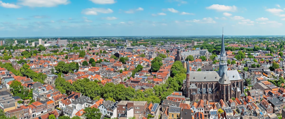 A cityscape with a prominent church and surrounding residential buildings.