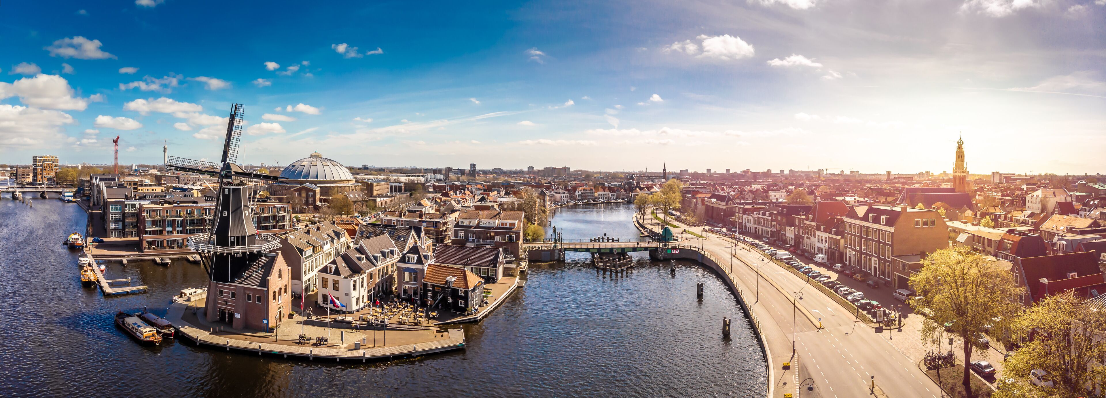 A river with boats, a bridge, and historic buildings along the banks.