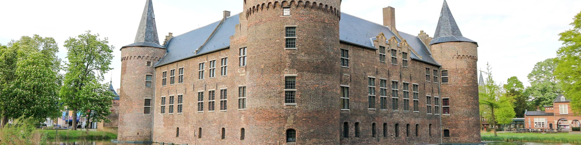 A historic castle with multiple towers and a moat.