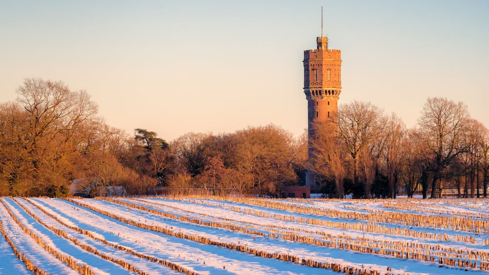 Dutch winter landscape with the water tower of Delden, in the eastern part of The Netherlands. Snow has fallen on a cold February day. The cities of Almelo and Hengelo and the German border are near.