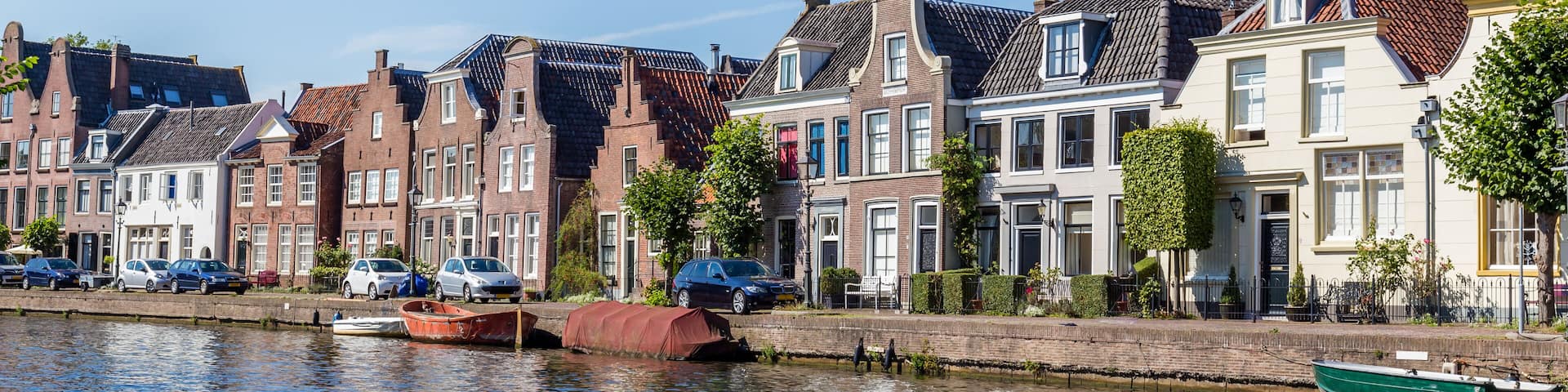 Village landscape as seen from the river Vecht of the old dutch village Maarssen with characteristic stepped gable houses.