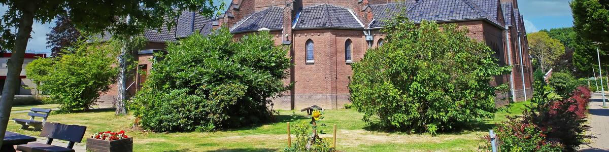 Beautiful neo gothic medieval St. Rochus church, green garden trees, now in use as Limburg archery museum - Steyl, Netherlands