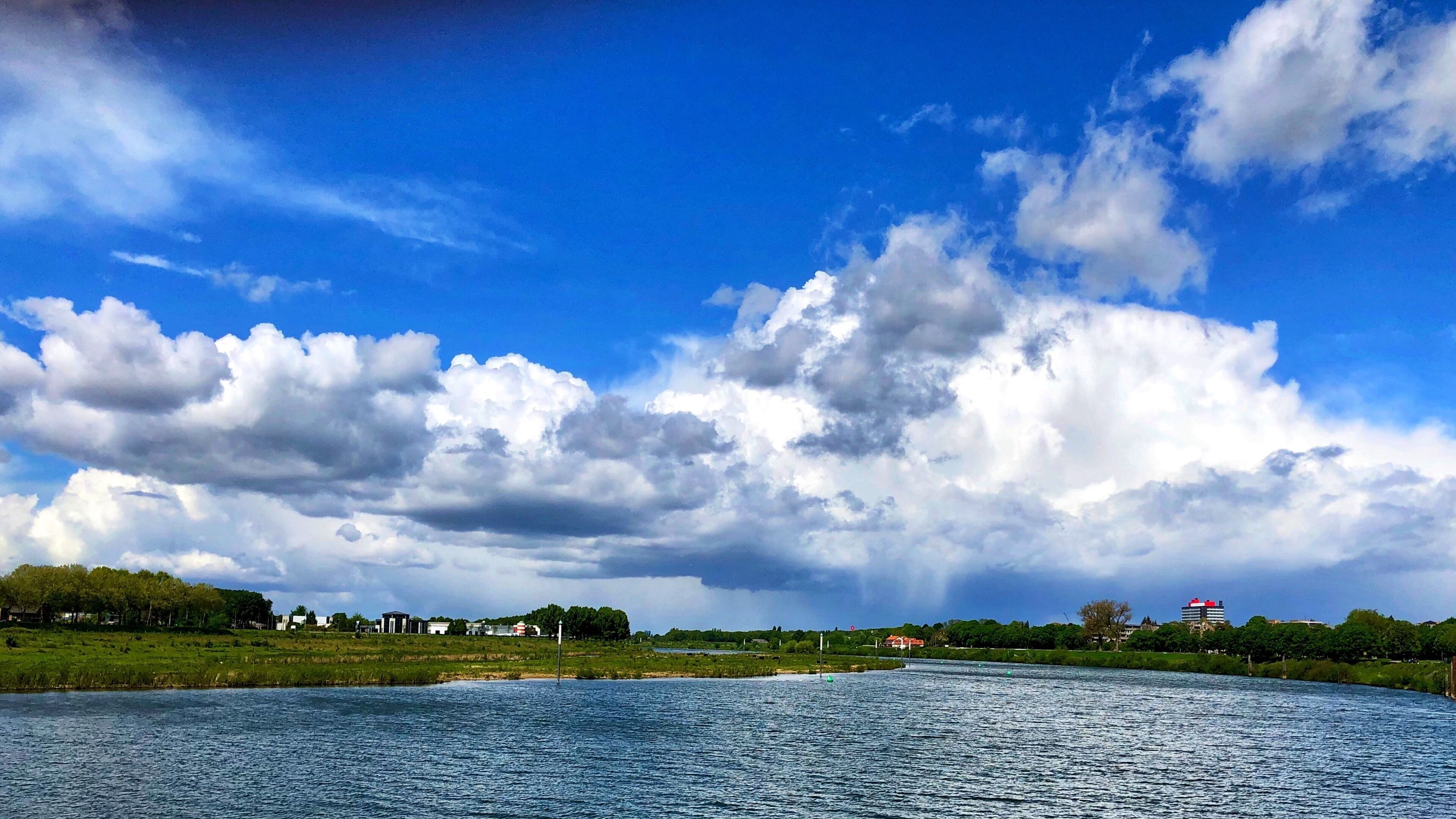 A river with a clear sky and scattered clouds.