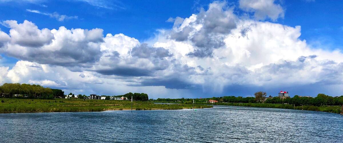 A river with a clear sky and scattered clouds.