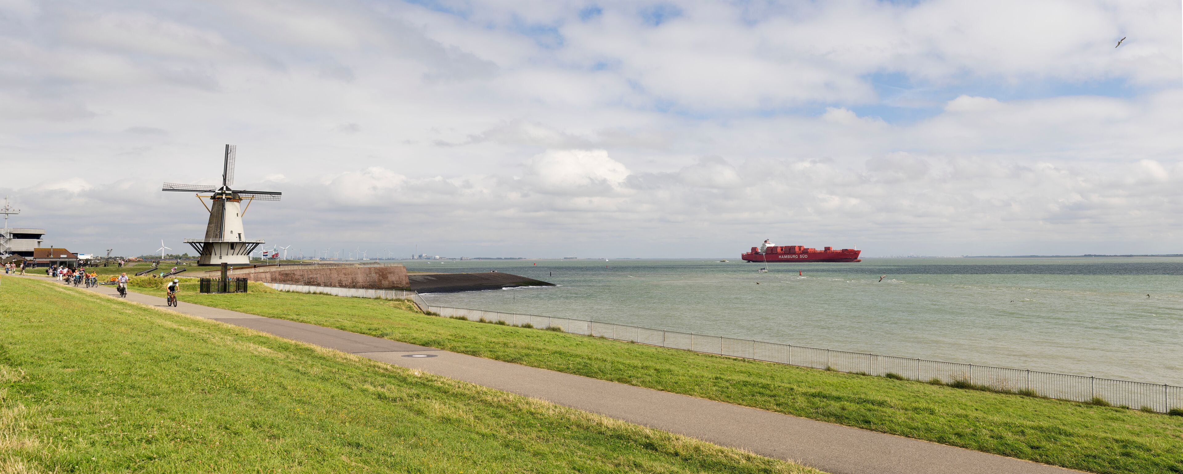 Dutch traditional windmill Oranjemolen at dike near Vlissingen the only windmill in the Netherlands that is located directly near the sea. province Zeeland