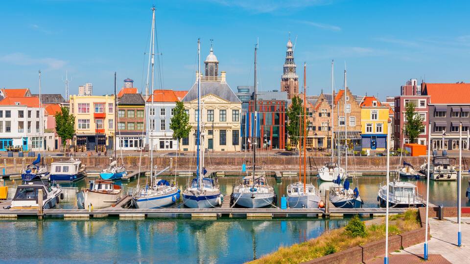 A harbor with colorful buildings and boats docked along the water.