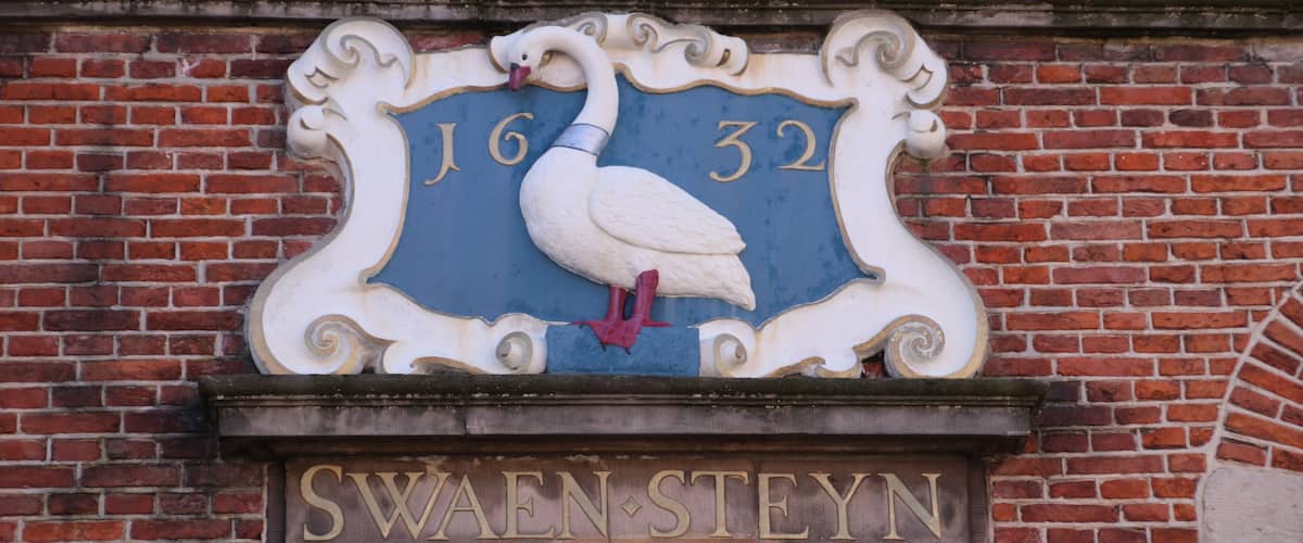 A swan sign with the numbers 16 and 32 above it, and the name 'Swansteen' below.