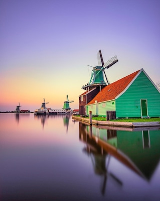 Row of old classic windmills in Zaanse Schans, Netherlands. Opportunities for great reflections when the wind is calm.
