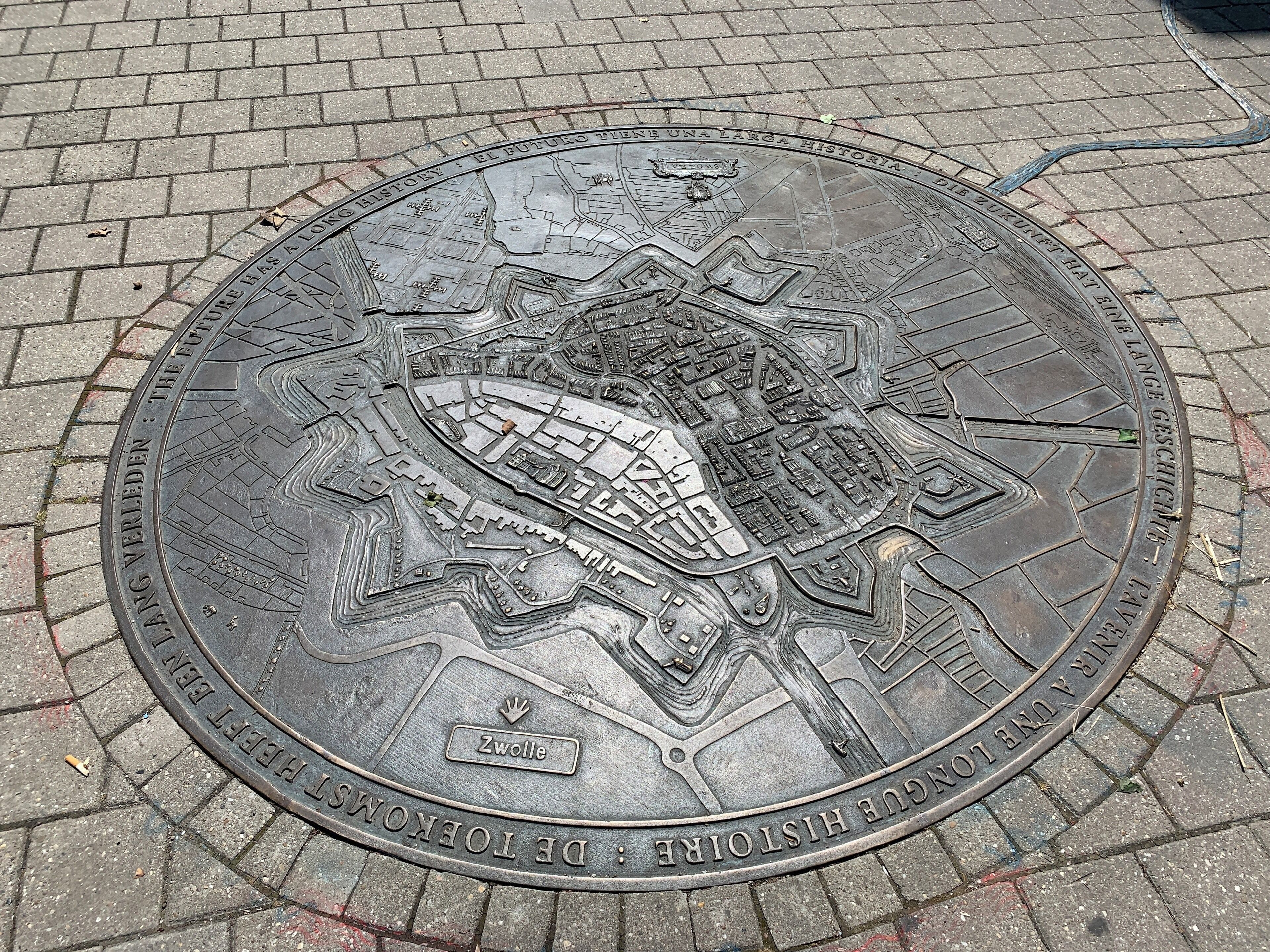 A detailed metal plaque with a map and text, likely a historical marker.