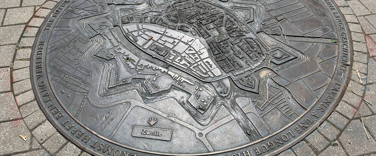 A detailed metal plaque with a map and text, likely a historical marker.