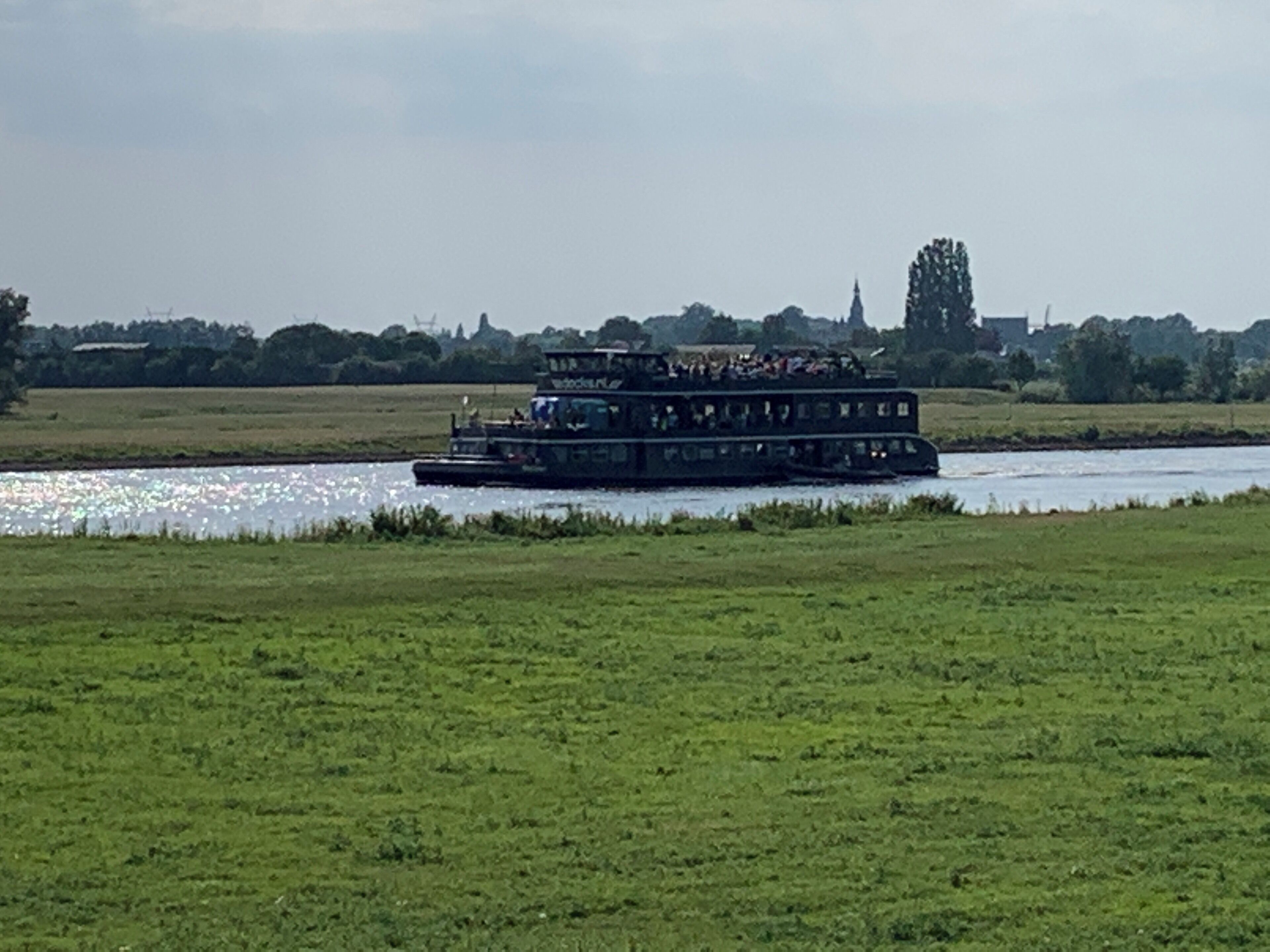 A river with a boat carrying passengers.