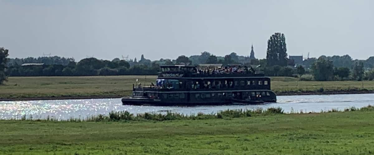A river with a boat carrying passengers.