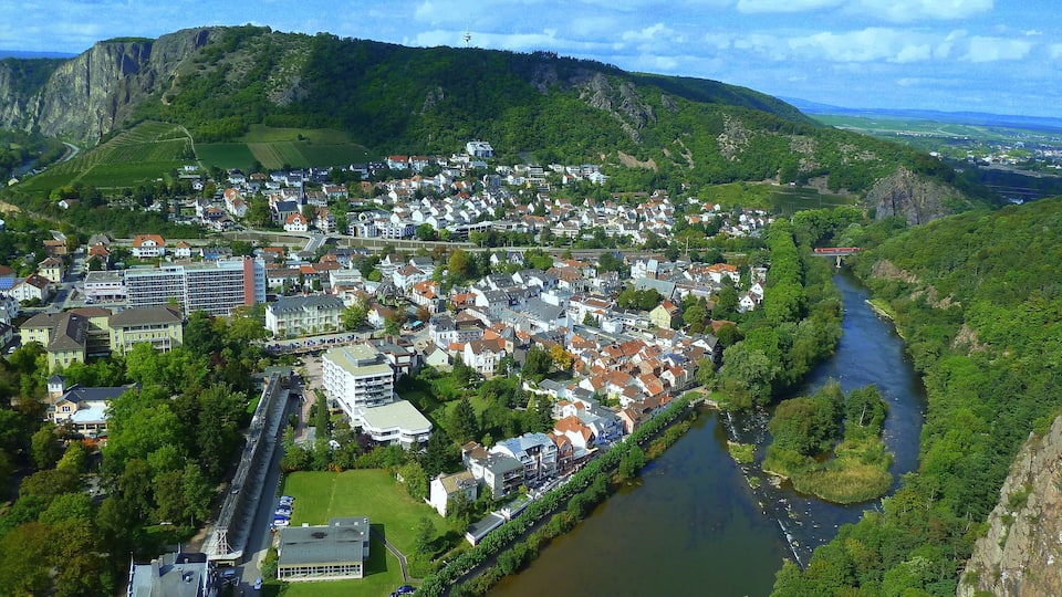A town nestled between hills, a river, and a bridge.