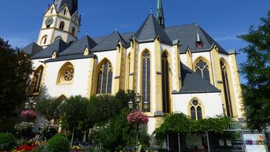 A historic church with a tall spire and a clock tower.