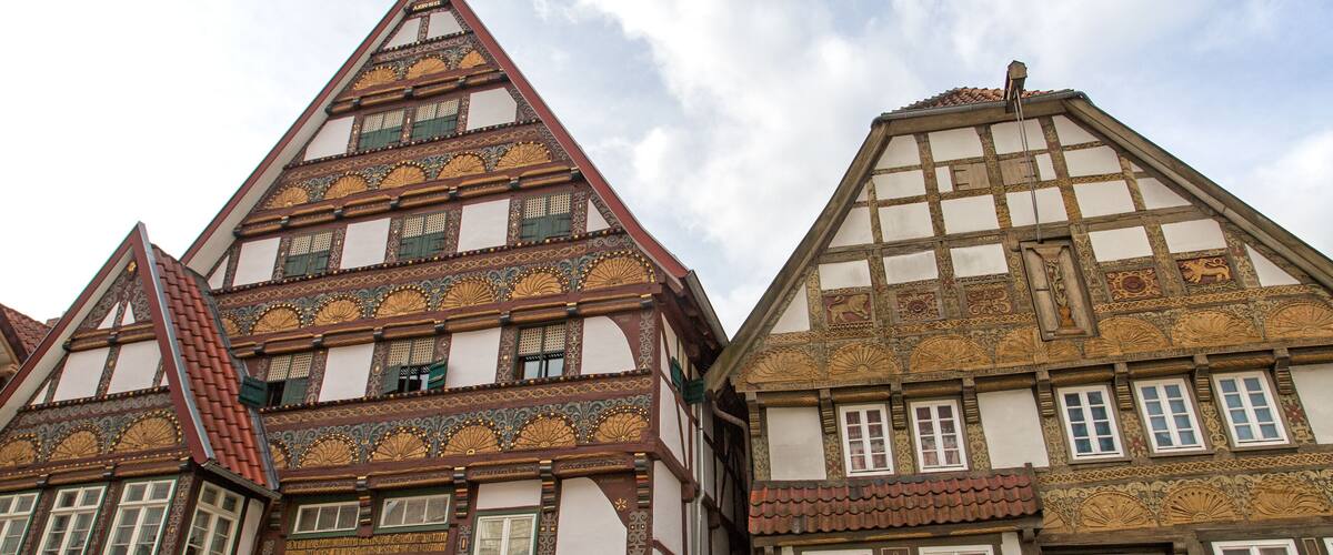 A traditional half-timbered building with intricate wooden carvings and a steeply pitched roof.