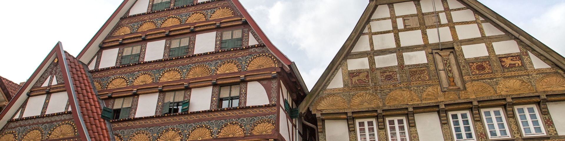 A traditional half-timbered building with intricate wooden carvings and a steeply pitched roof.