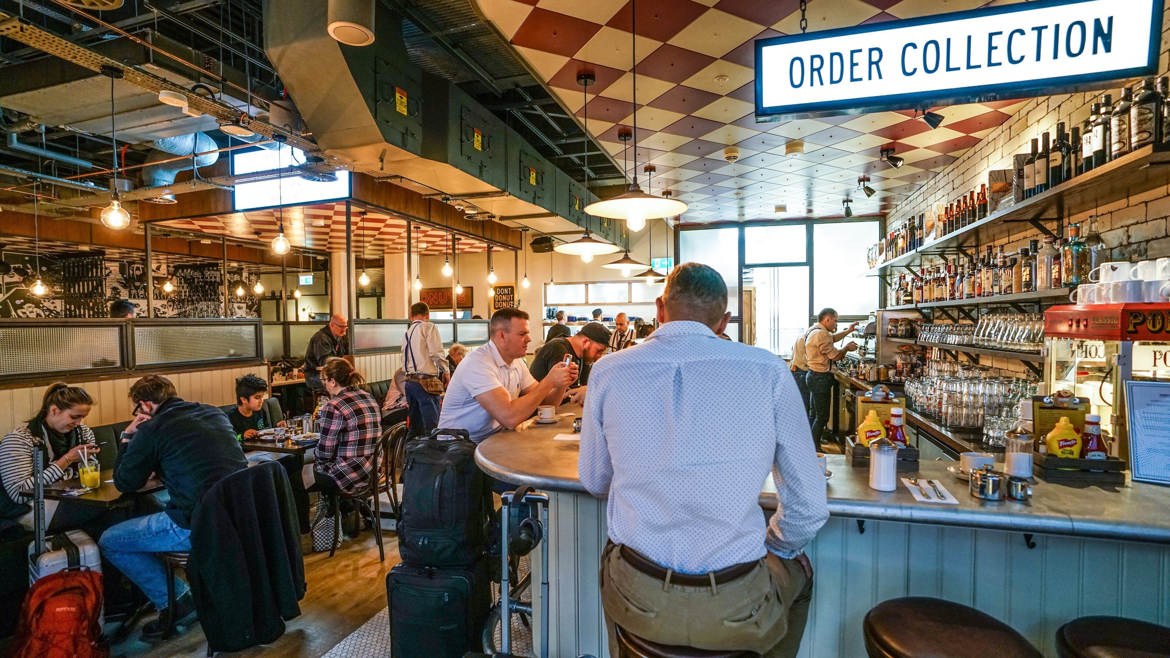 London featuring a bar and interior views as well as an individual male