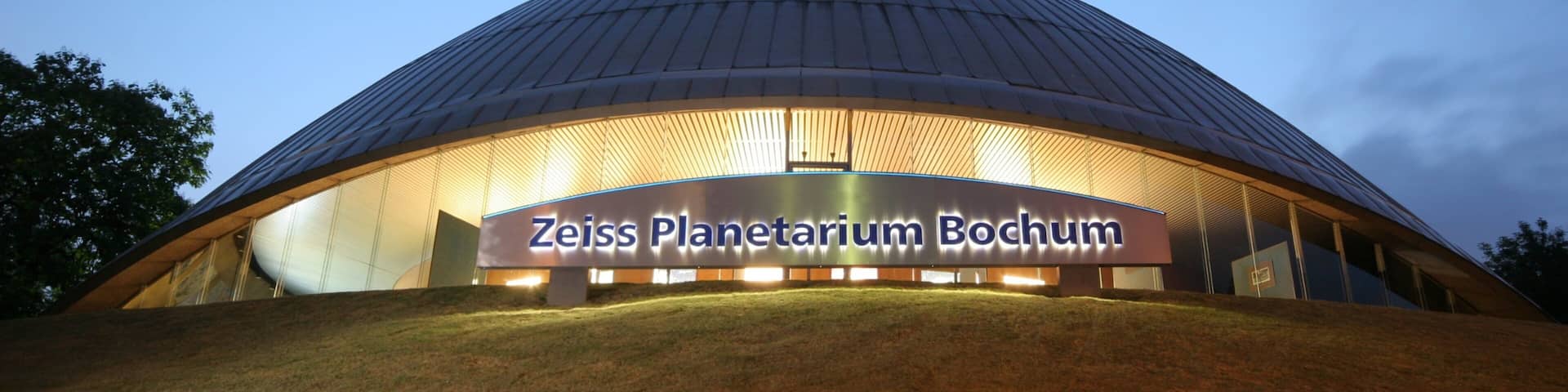 Bochum showing signage, a sunset and modern architecture