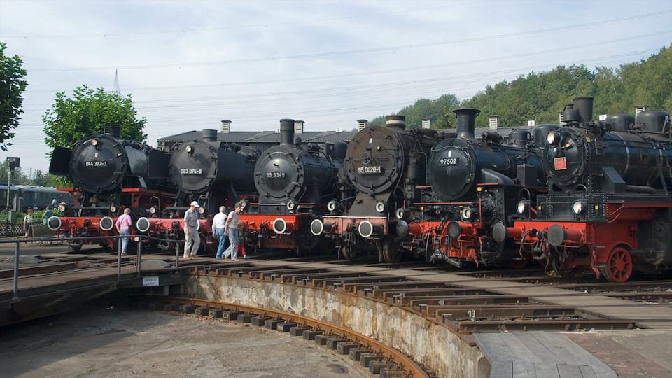 Una hilera de locomotoras de vapor antiguas estacionadas en una estación de tren.