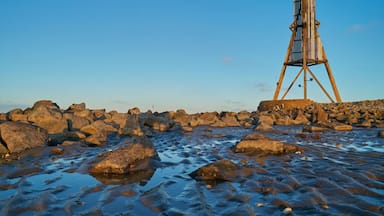 A rocky shoreline with a wooden structure.