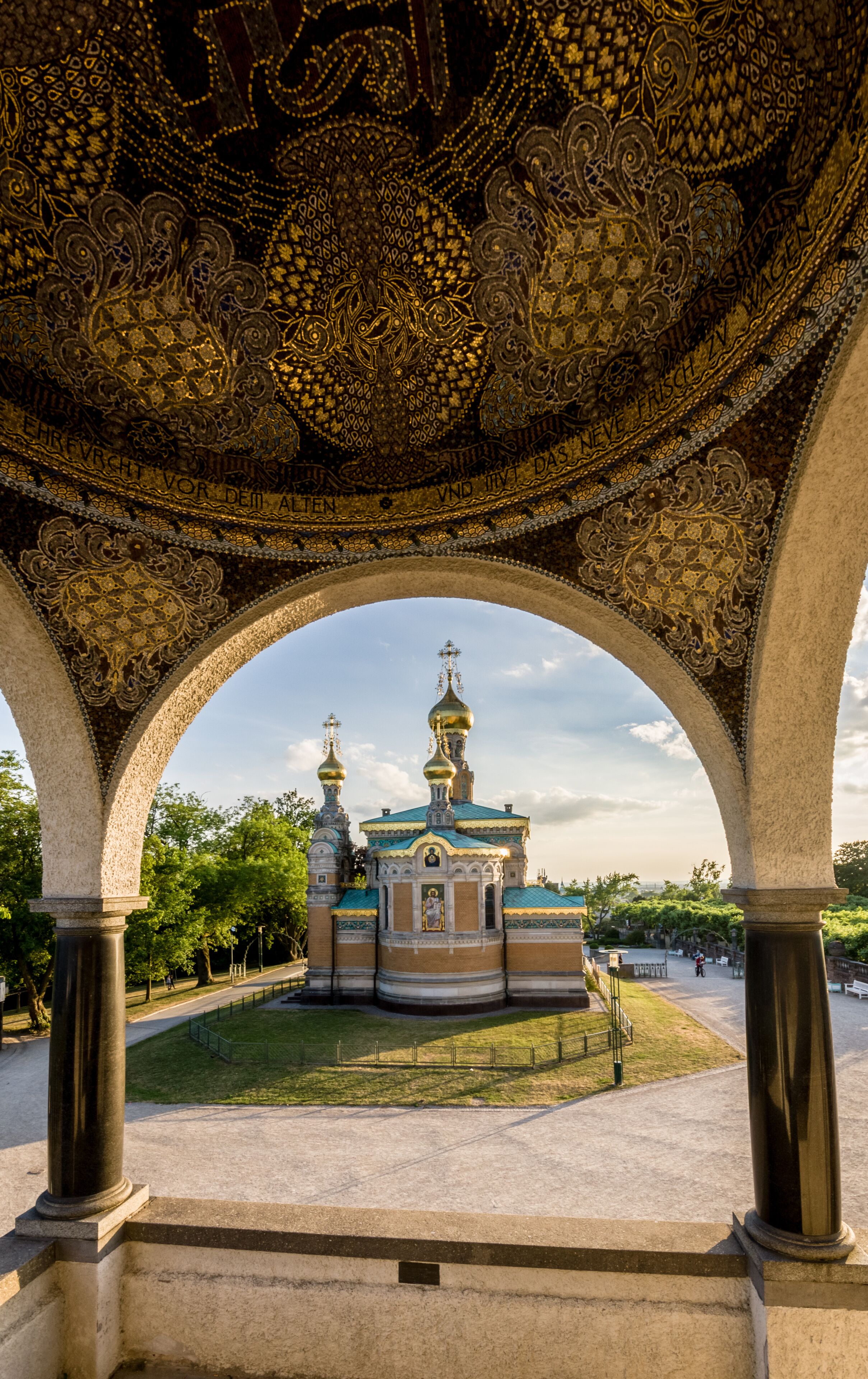 An ornate architectural structure with intricate designs and a central building with domes.