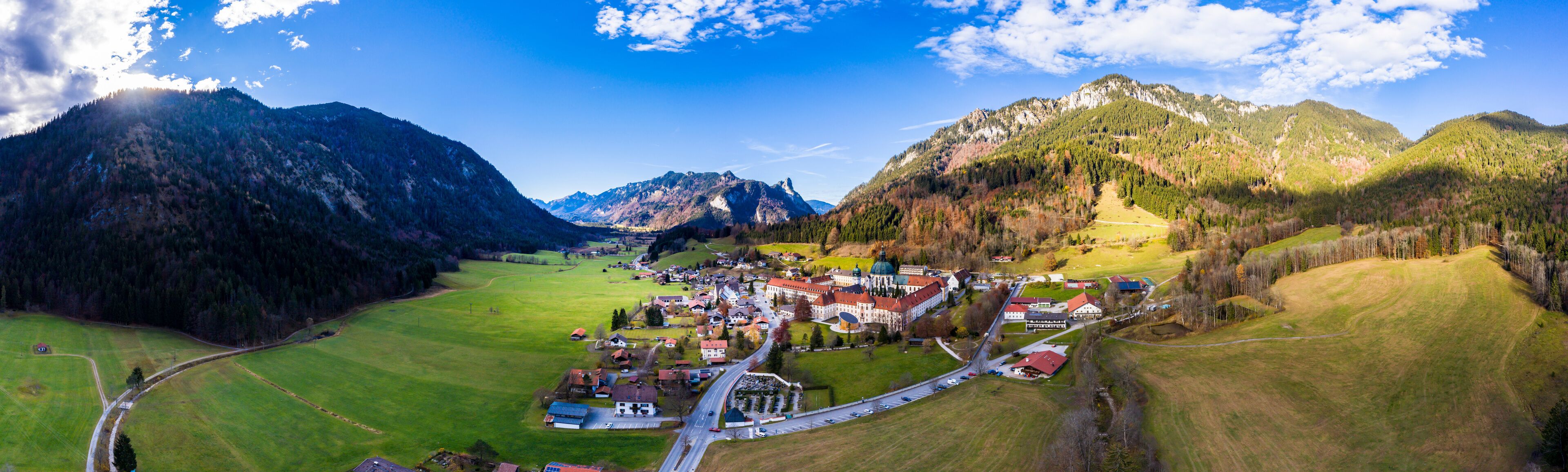 A mountainous landscape with a village nestled in a valley.