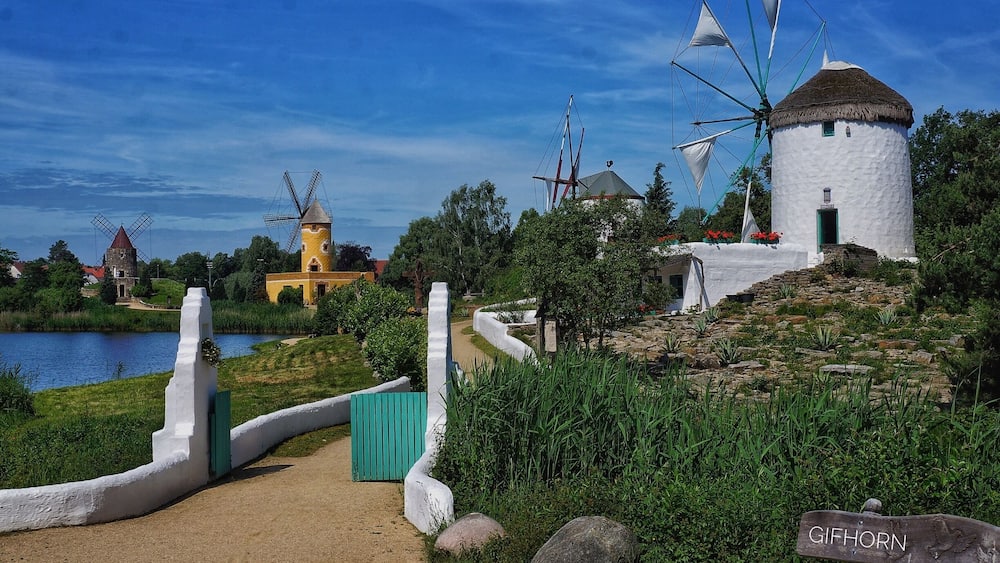Windmills, a lake, and a path with a sign reading "GIFHORN".