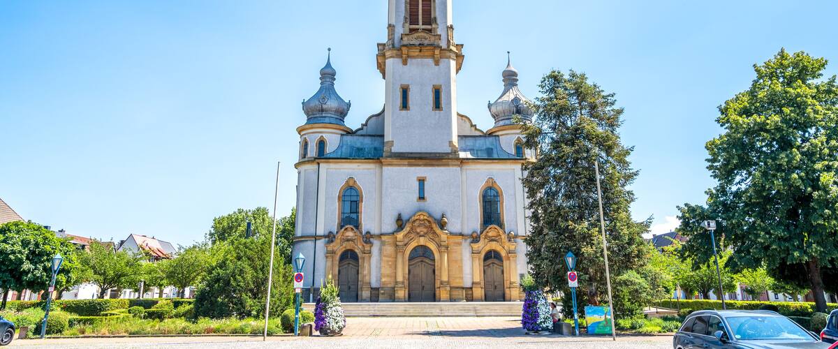 A historic church with a tall bell tower and a clock.