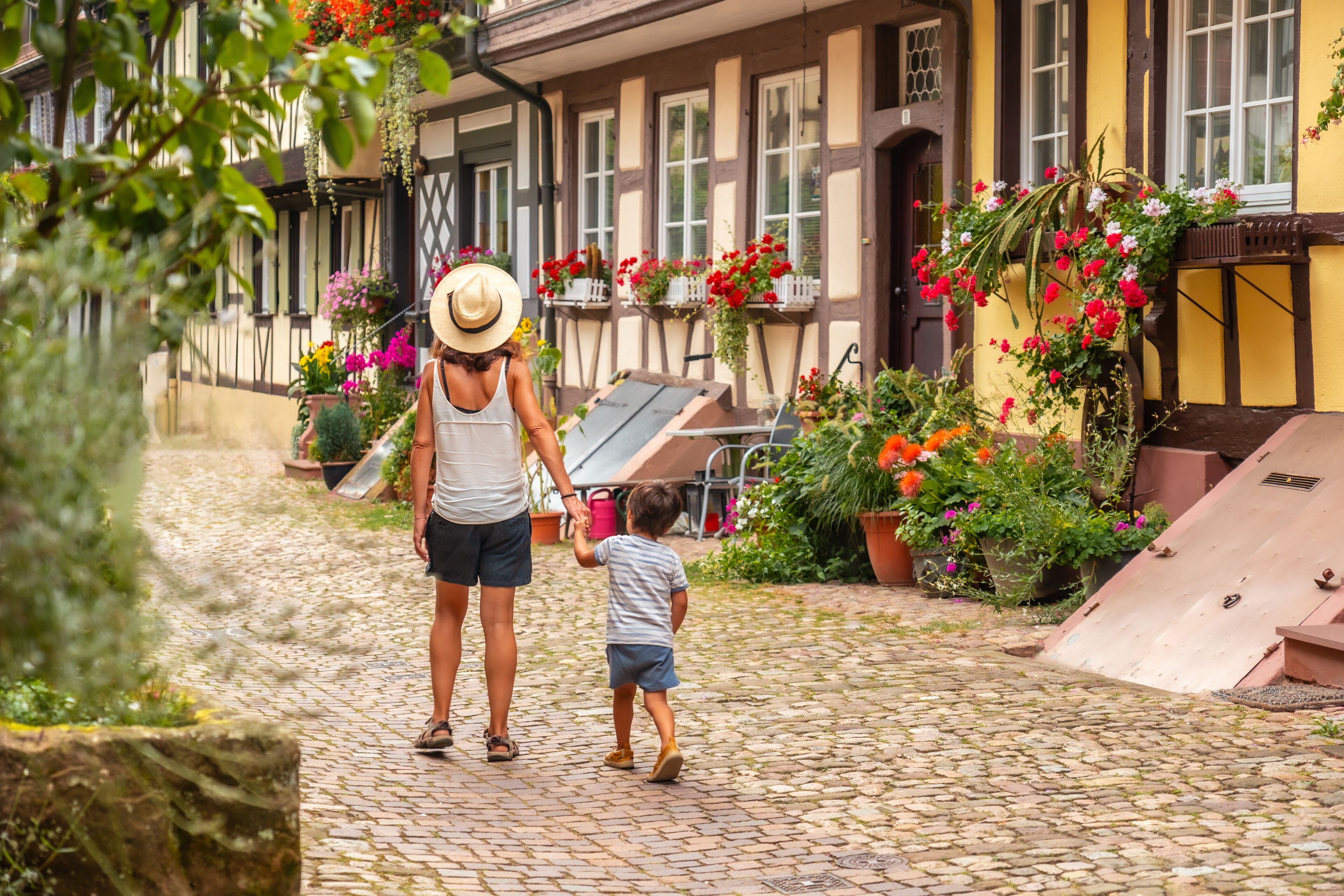 Mother and son in the medieval village in the old town of Gengenbach in the Black Forest, Germany, family vacation concept