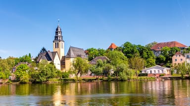 A river with a church and residential buildings along the banks.