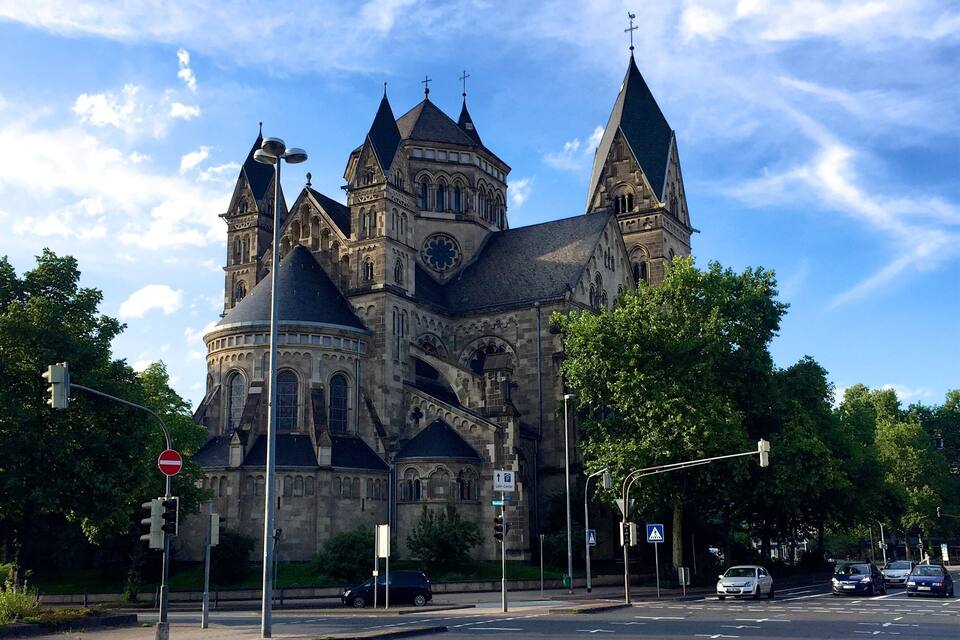 A historic church with multiple spires and a large circular window.