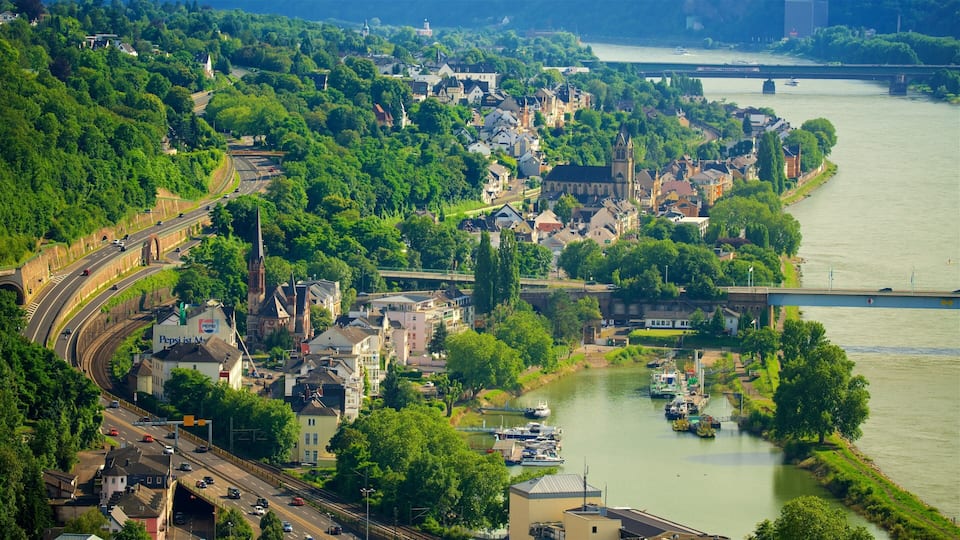 A riverside town with a church, a bridge, and a highway.