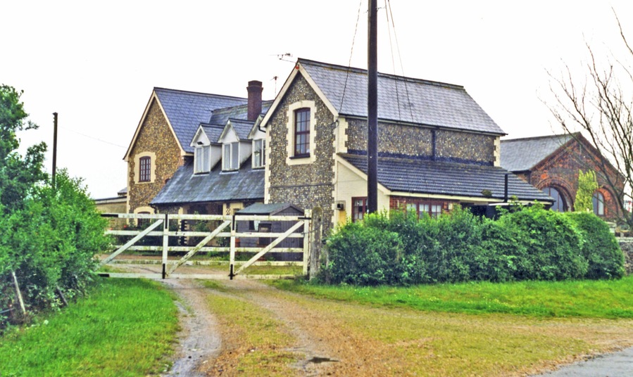 Former Holme Hale station. View eastward, towards Thetford: ex-GER Thetford - Swaffham line. The station closed with the withdrawal of passenger services on the line from 15/6/64, but goods services continued Swaffham - Watton until 14/4/65. It has become a substantial private house.