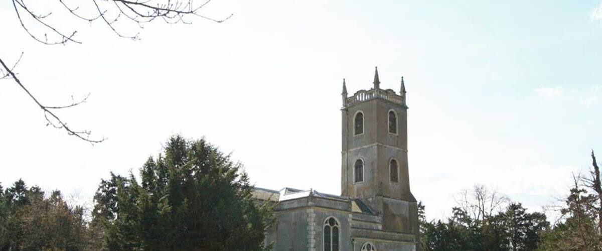A church with a tall tower and arched windows.