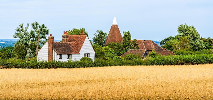 Landcape of a traditional English country house on the fields in Kent, England, UK