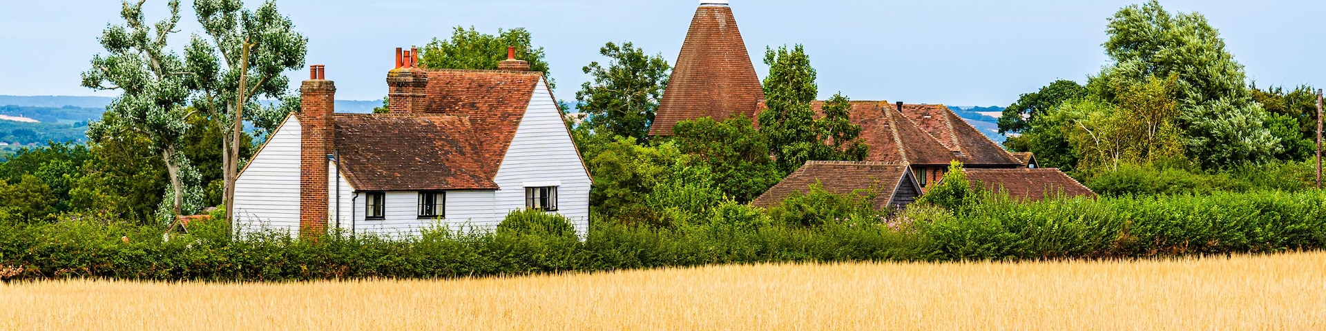 Landcape of a traditional English country house on the fields in Kent, England, UK