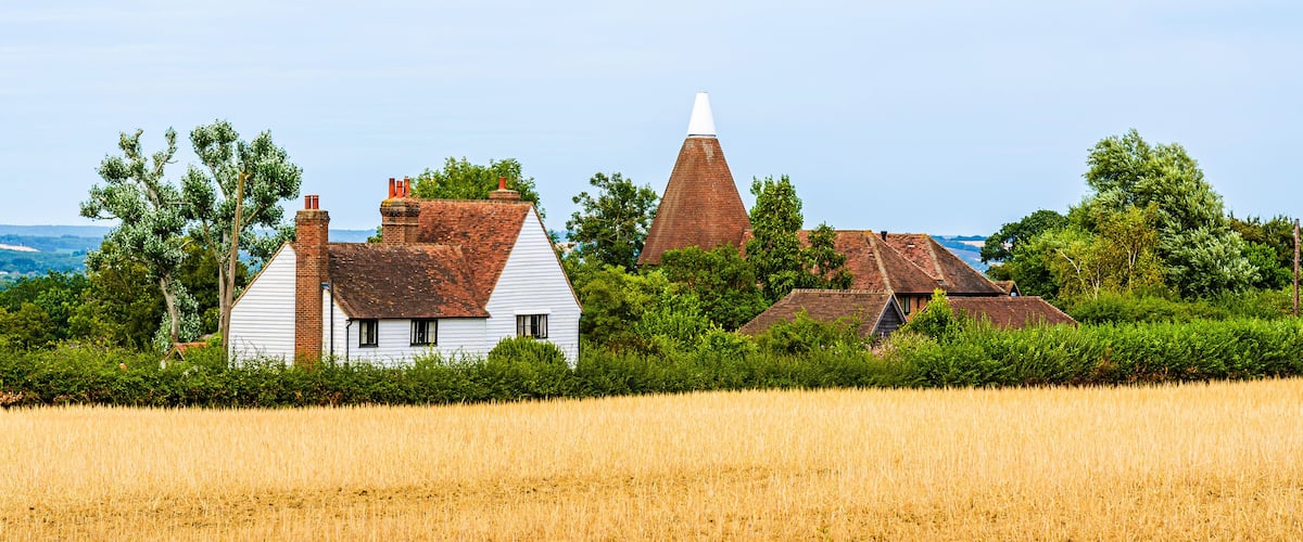 Landcape of a traditional English country house on the fields in Kent, England, UK