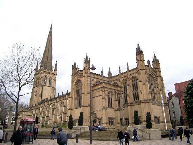 A large Gothic-style cathedral with multiple spires and a prominent clock tower.