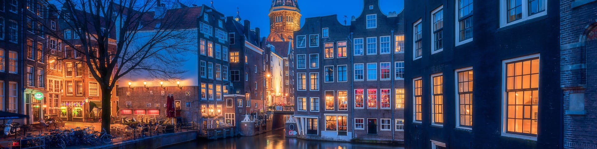Amsterdam night, red light district night with colorful windows near the basilica of saint nicholas