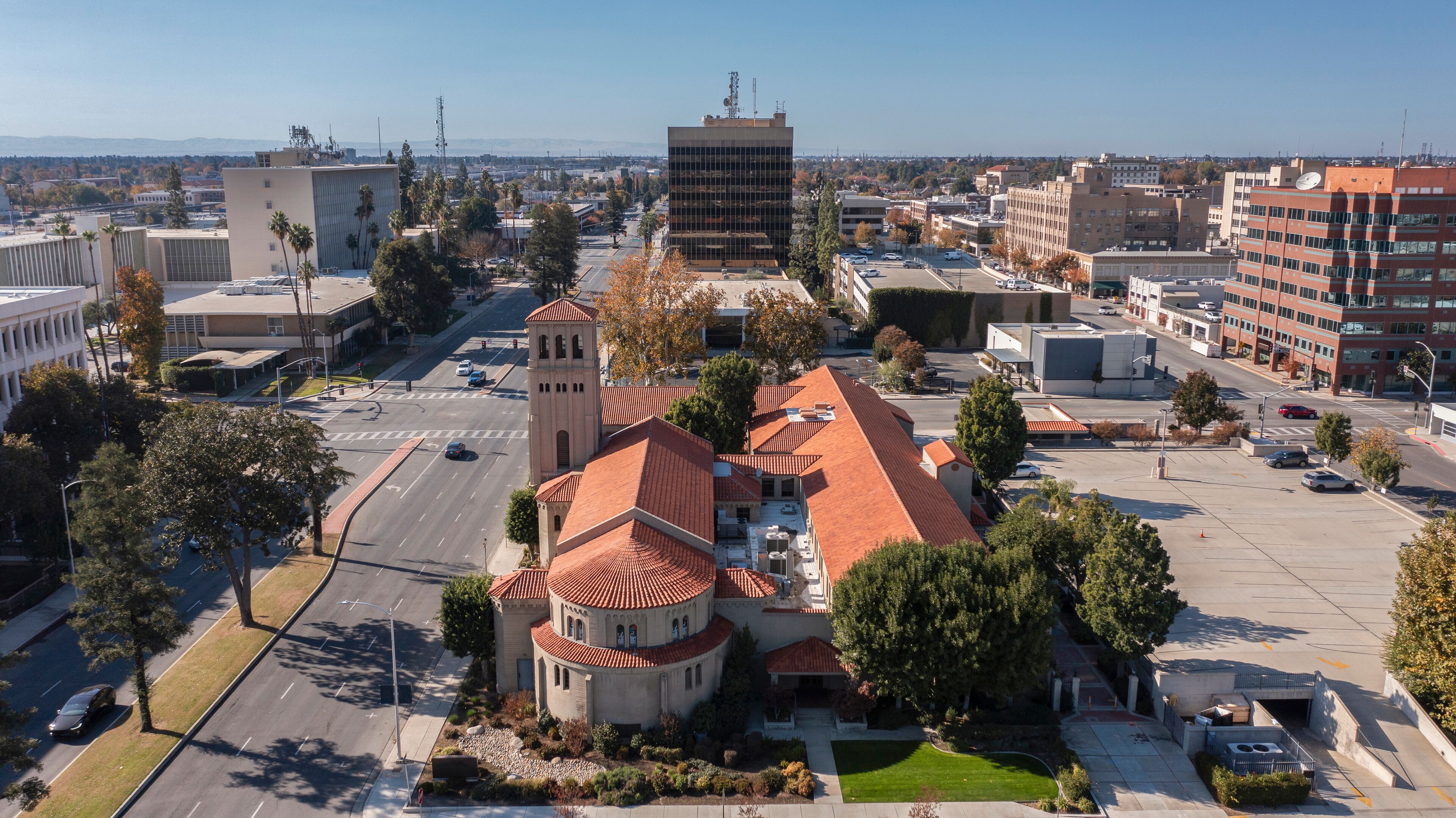 Bakersfield, California, USA - November 24, 2023: Afternoon sun shines on a historic church and urban core of downtown Bakersfield.