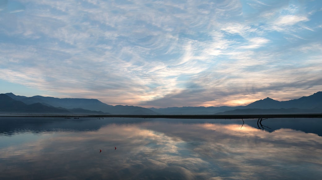 Sunrise cloudscape reflected in Lake Isabella in the southern Sierra Nevada mountains in California United States