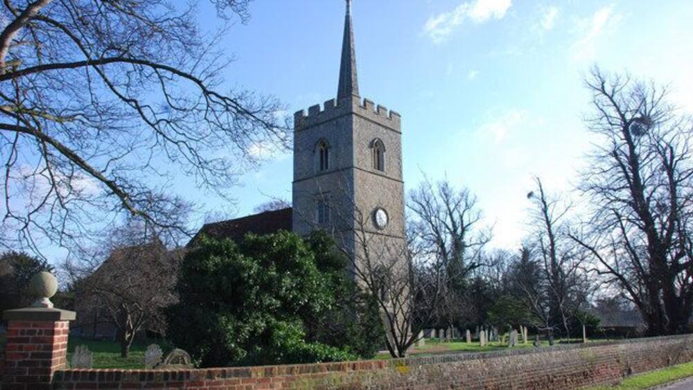 A church with a tall steeple and a clock tower.