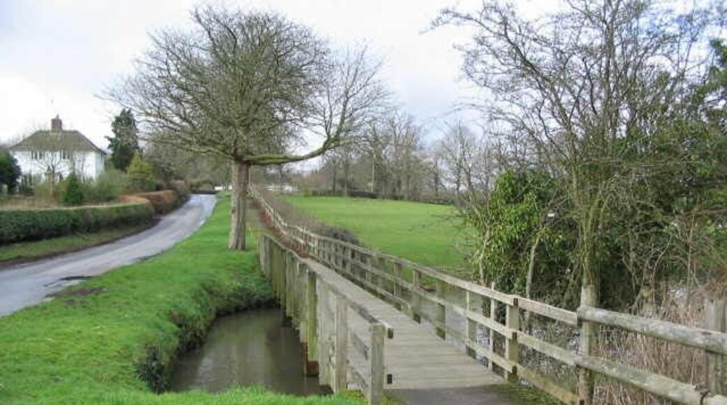 Watery Lane. Horningsham A view looking west along Watery lane showing the wooden footbridge over the millpond at Horningsham.