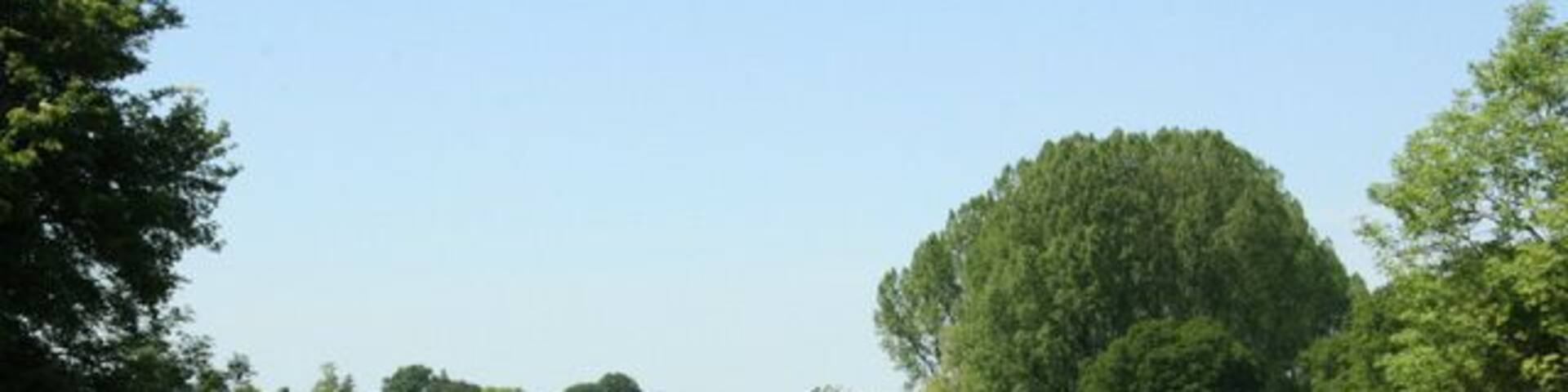 Valley at the end of Pottle Street The stream running through this valley feeds the artificial lakes in Longleat Park.